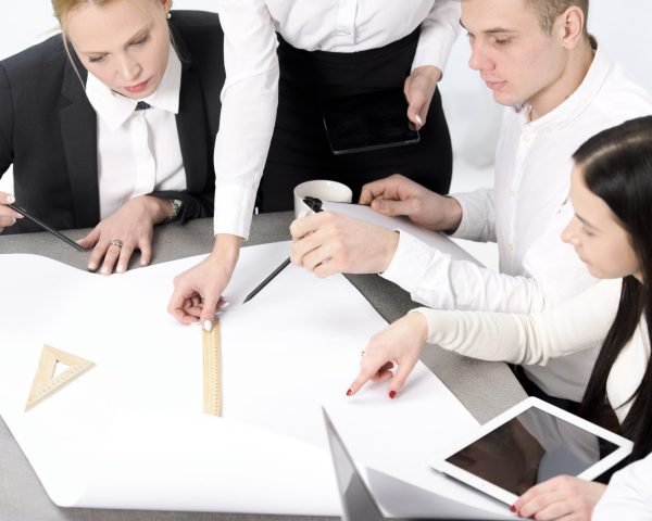group-businessman-businesswoman-planning-project-paper-desk group-businessman-businesswoman-planning-project-paper-desk