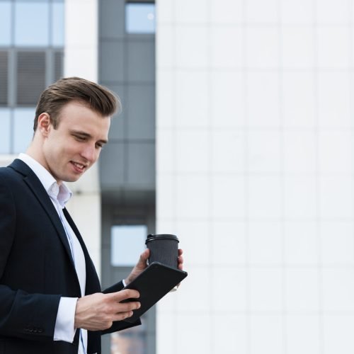 low-angle-businessman-using-tablet